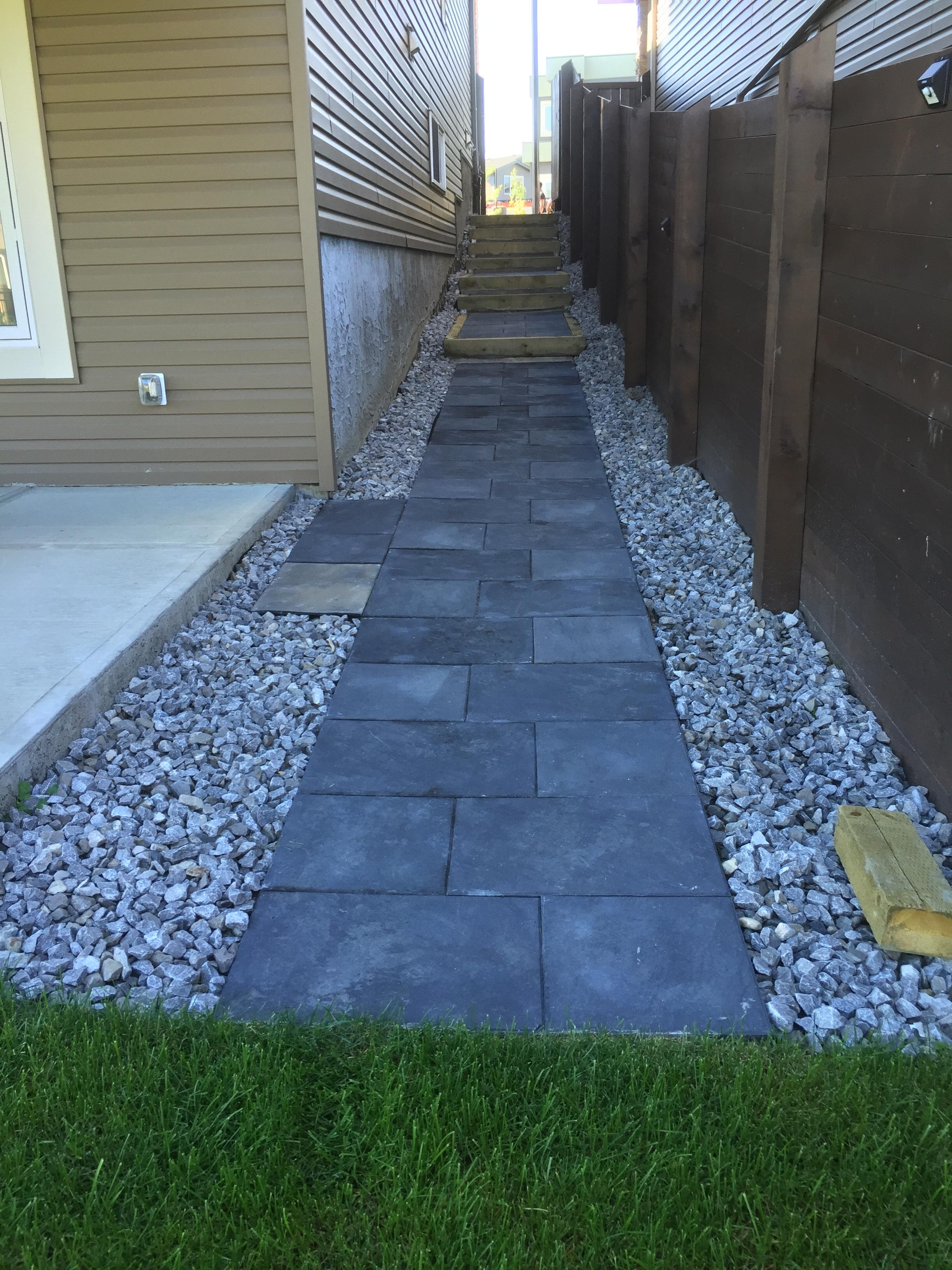 Side yard dark slate stepping stone pathway with gravel surround
